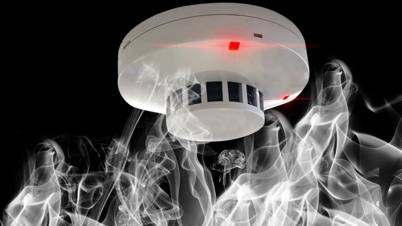 Main blog image of a smoke detector and smoke.