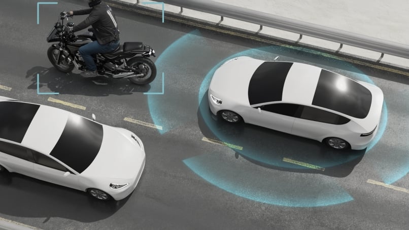 Car on highway road with ADAS radar scanning other vehicles.