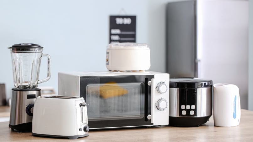Household appliances on countertop in a kitchen.