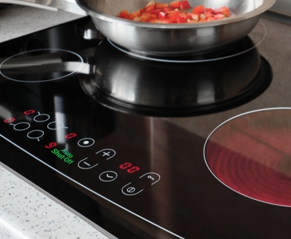 Auto shut-off indicator on control panel turned of modern electric cooking stove.