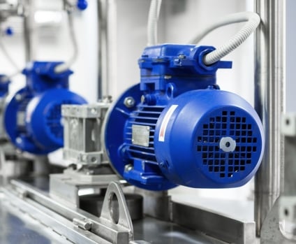Electric motors on tanks for mixing liquids in beverage production factory.