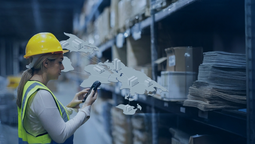 Warehouse worker tracking assets on a smart phone.