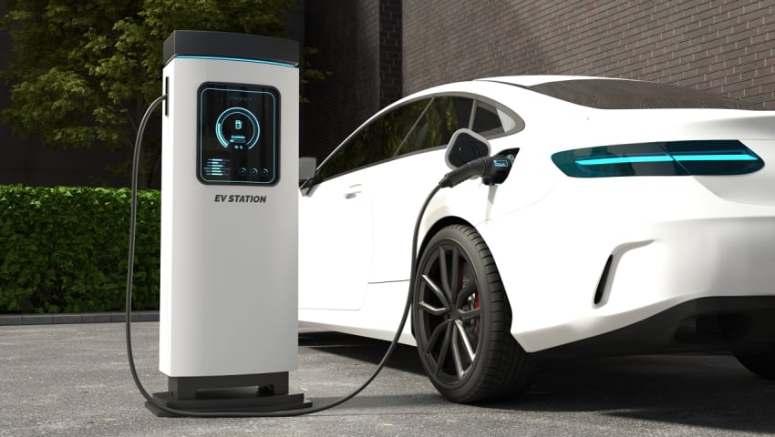 White electric car connected to charging station