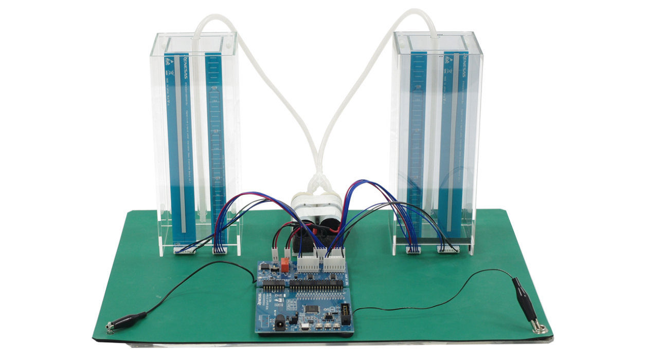 Front view of the capacitive touch liquid level indicator reference design with two transparent tanks, connecting tubes, sensors, and a CPU board and control board.