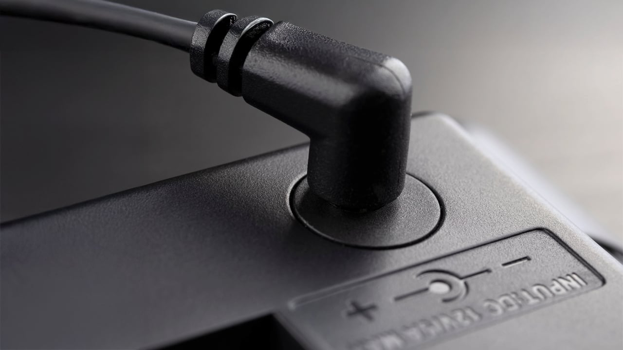 Inserted black 12-volt adapter plug.